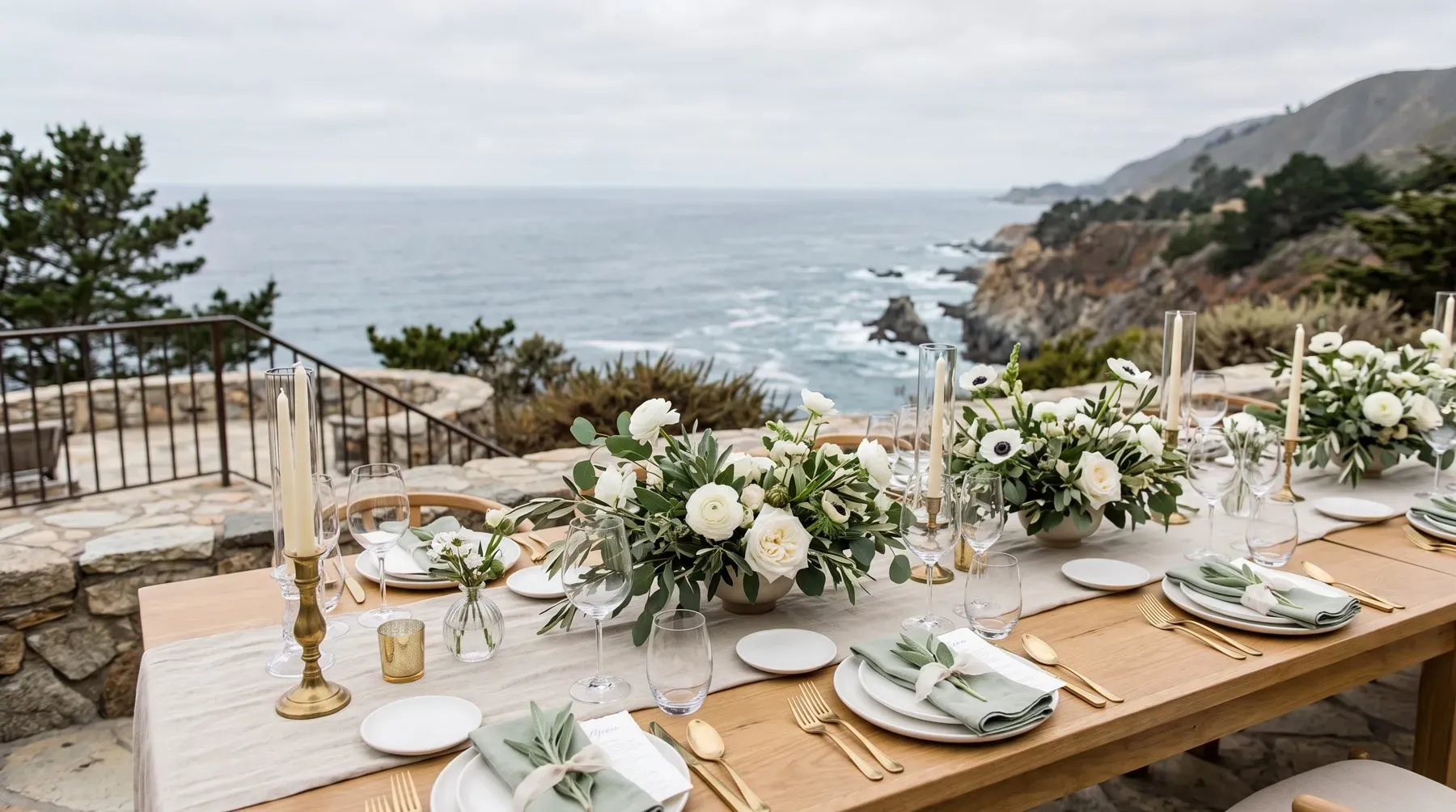 Guest tables set on an open coastal terrace at golden hour.