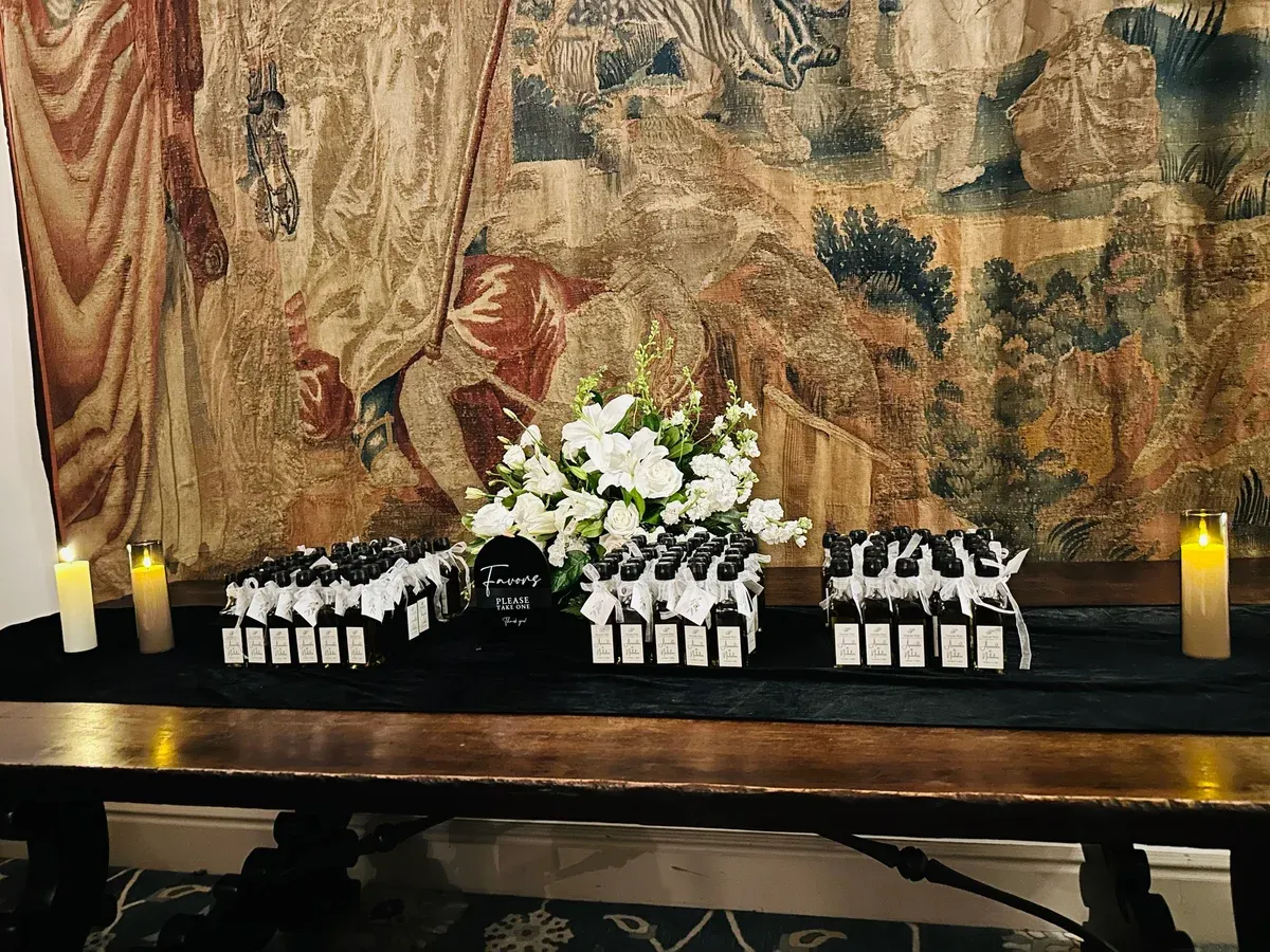 A grand piano dressed with a low ivory floral garland along its curve for the cocktail hour.